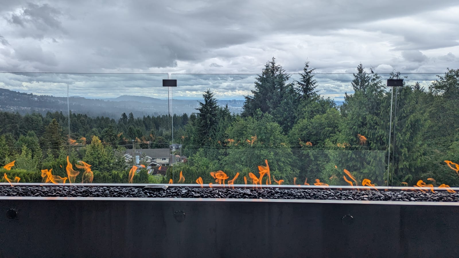 Custom stainless steel linear fire pit installation in West Vancouver